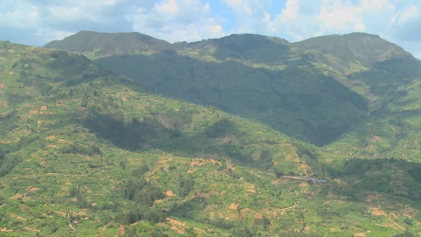 Time Lapse shot of clouds and shadows moving over the rich terraced farmland of Rwanda.