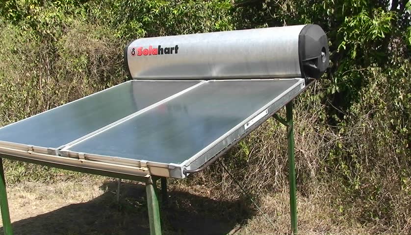 A solar water heater stands outside, and a sign instructs people to beware of monkeys.