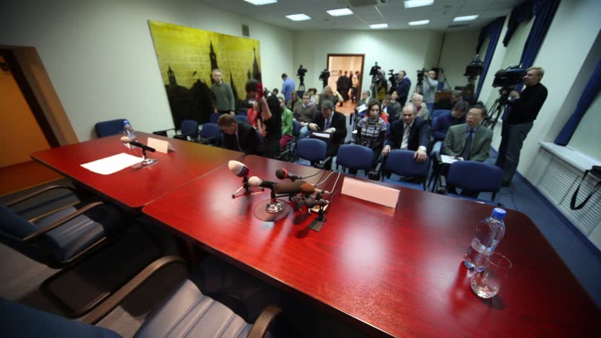 MOSCOW - NOVEMBER 19: Man setup microphone when other russian and foreign journalists wait during meeting of Chairman of Federation Council S.M. Mironov on November 19, 2010 in Moscow, Russia.