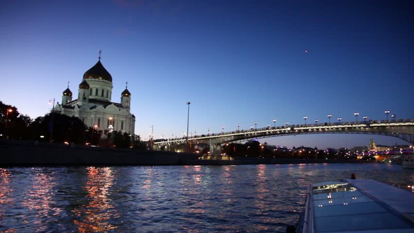 Ship sail down the river, Christ Savior Cathedral and Patriarchal Bridge at evening in Moscow, Russia