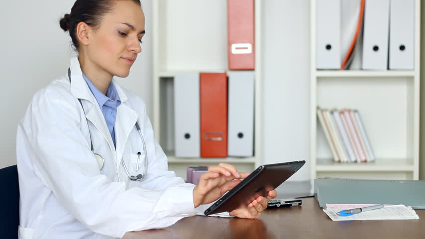 Portrait of female doctor with tablet computer in her office
