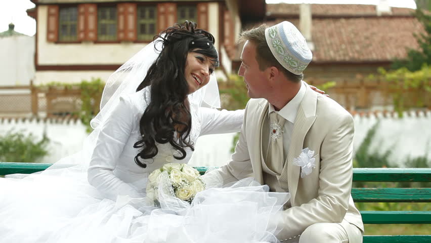 Crimean Tatar newlyweds sitting in the park Bakhchisaray Palace (Hansaray, Khan's Palace) Bakhchisaray, Crimea, Ukraine