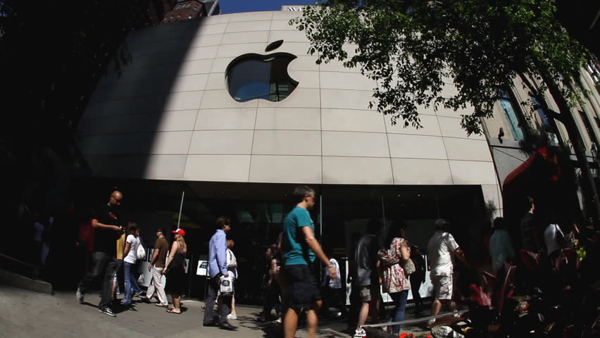 CHICAGO - CIRCA SUMMER 2010: Pedestrians walking by Apple store, circa summer 2010 in Chicago. Apple Inc. is an American multinational corporation that designs and markets consumer electronics, computer software, and personal computers. 