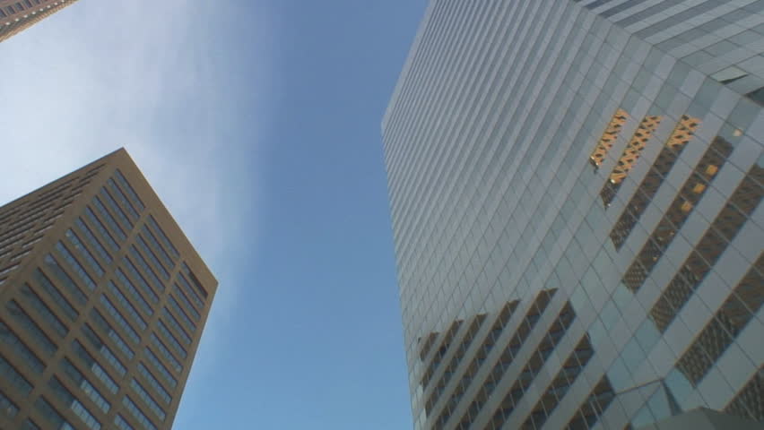 Street to sky tracking shot of office buildings in downtown Denver, Colorado