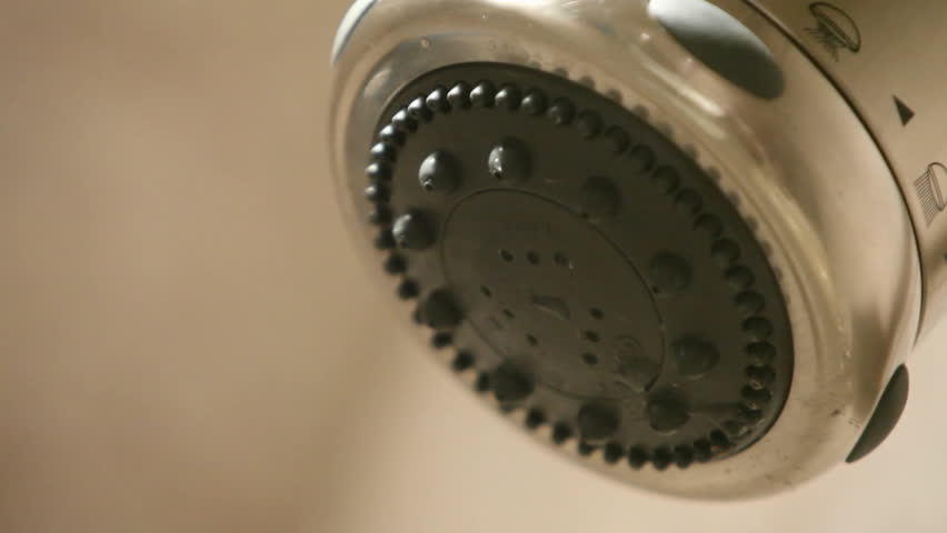 A shower head turns on, then off.