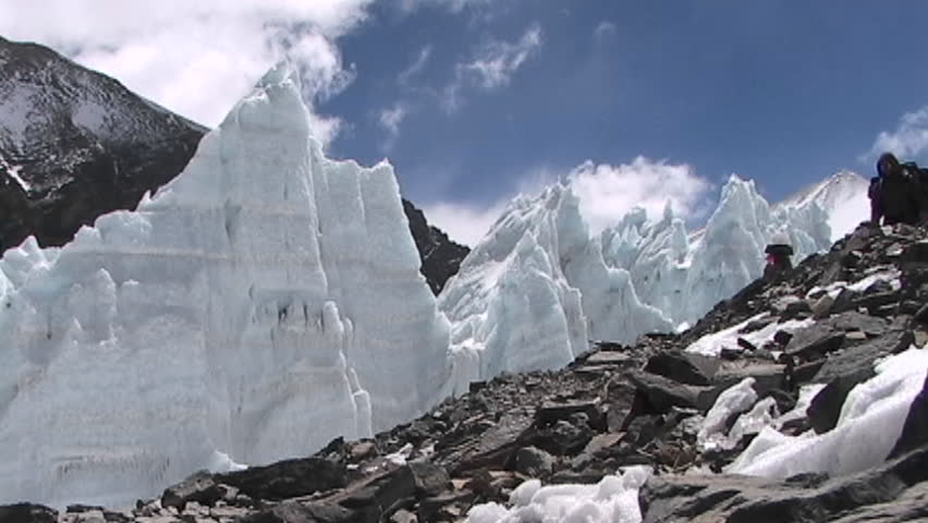 MOUNT EVEREST, TIBET - CIRCA 2005: Climbers walk in front of ice pyramids circa 2005 in Tibet.