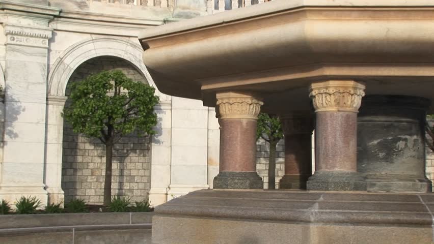 The camera pans up the facade of the U.S. Capitol building, from the base of its massive fountain to the cast-iron statue of Armed Freedom on top of the dome.