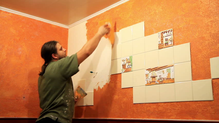 Master applies colored wax on ornamental plaster. 