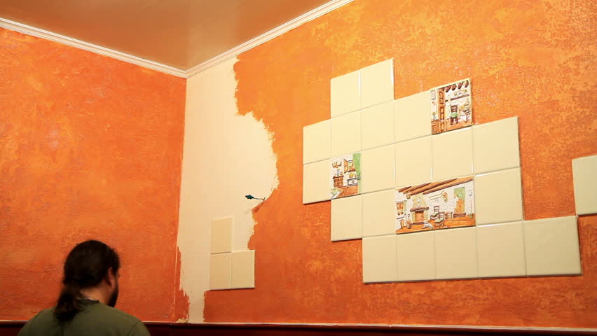 Master applies colored wax on ornamental plaster. 