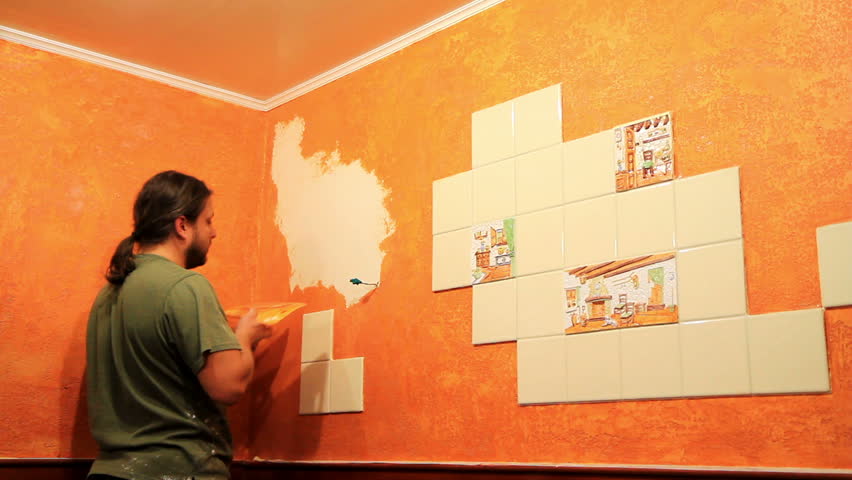 Master applies colored wax on ornamental plaster. 