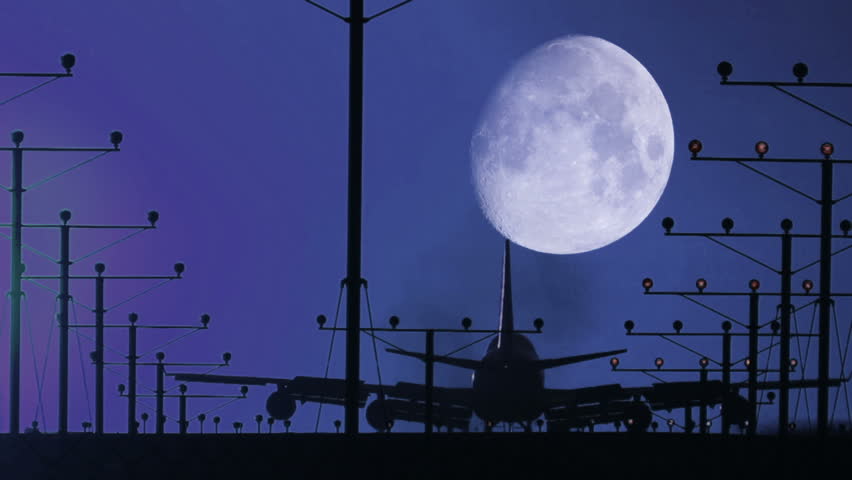 HD footage of a night landing by a jumbo jet as it cross the moon, then rack focuses out at the end.  Audio included
