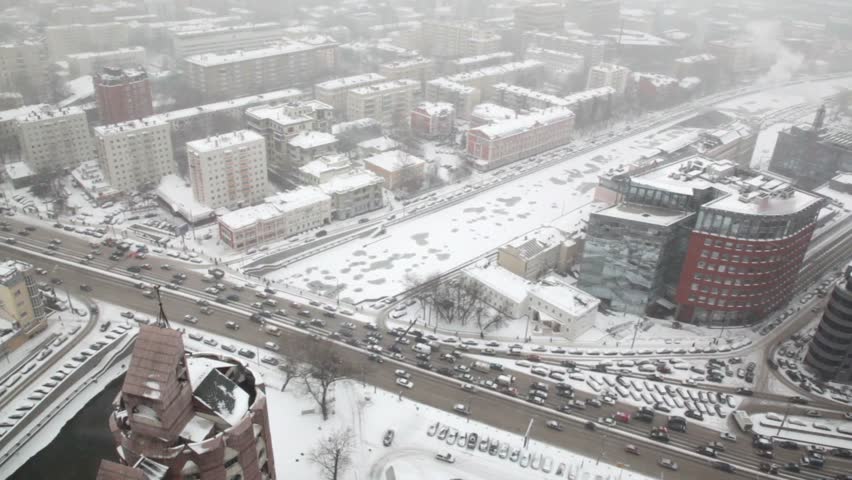 Houses and street traffic on Sadovoye Koltso in Moscow at winter, view from above through window