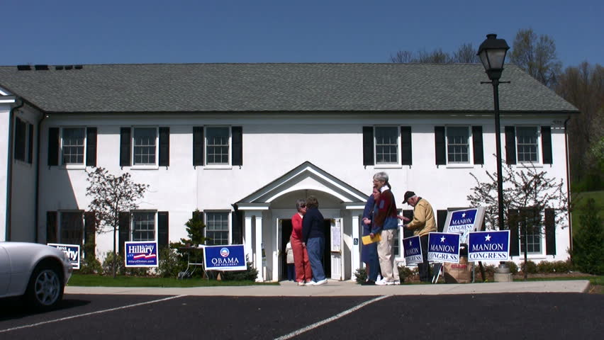 View of Primary Election held at a church with Democrats and Republicans handing out literature USA