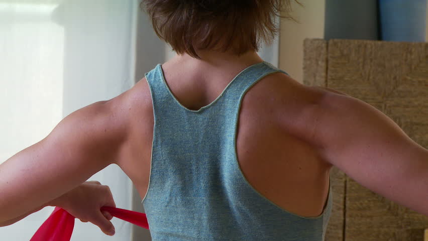 Close up of young woman performing pilate move on a mat