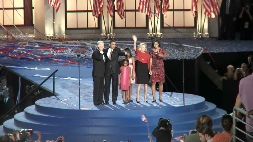 DENVER, COLORADO - CIRCA 2008: Presidential nominee Barack Obama and his Vice Presidential pick Joe Biden with their families wave to a packed Invesco Field at the end of the 2008 Democratic National Convention.