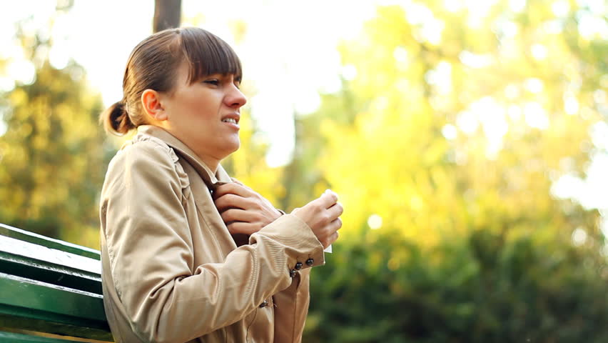 Sick woman blowing his nose into tissue, outdoors 
