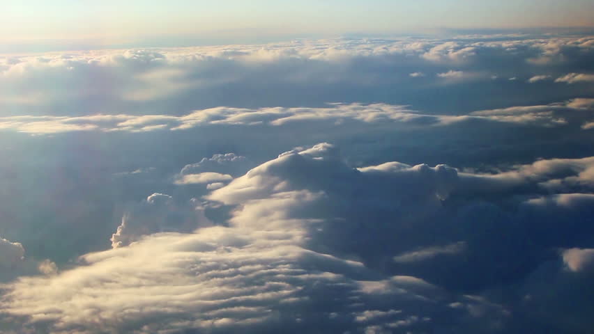 Aerial view of clouds over landscape from airplane.