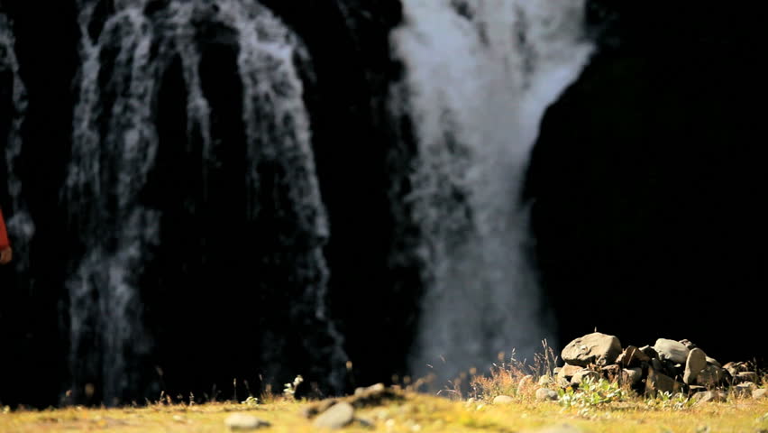 Lone Female on Hiking Expedition by Waterfall