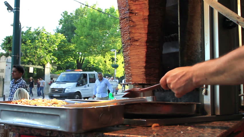 ISTANBUL - JUNE 6: Man cooks and sells doner kebab in a small buffet at Sultanahmet region on June 6, 2011 in Istanbul. Kebab refers to a variety of grilled or broiled meat in Middle Eastern cuisine