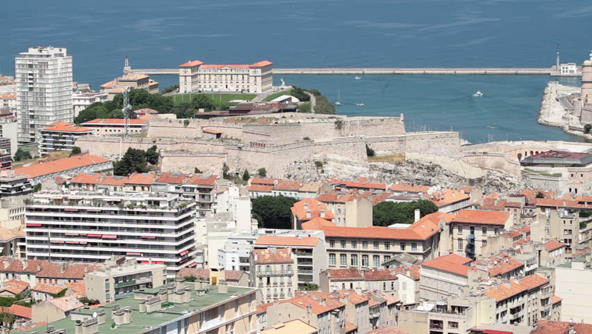 Marseille France Fort Saint Jean on edge of marina on Mediterranean Sea. Congested city with old ancient buildings.