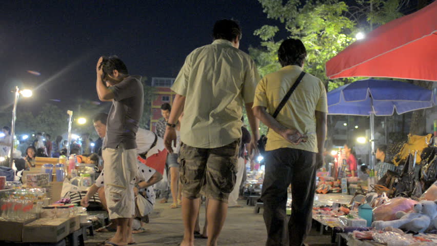 BANGKOK, THAILAND - NOVEMBER 2011: People browse and shop at a night market circa November 2011 in Bangkok, Thailand.