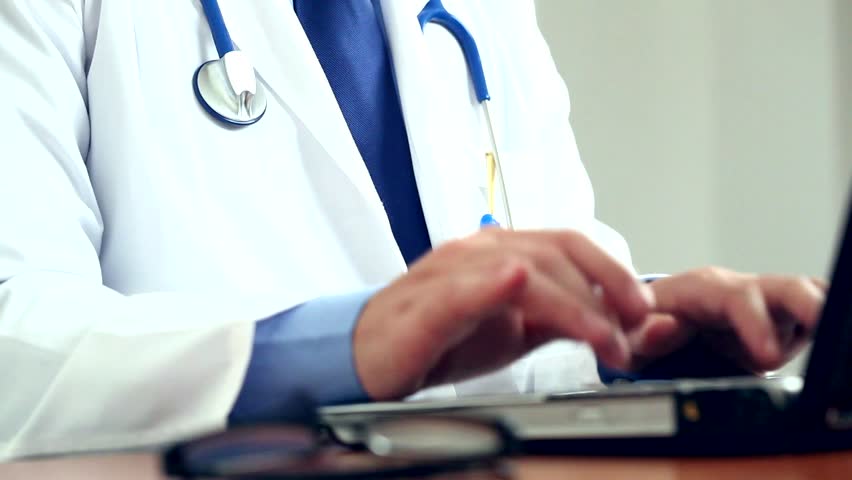Doctor working at his laptop
