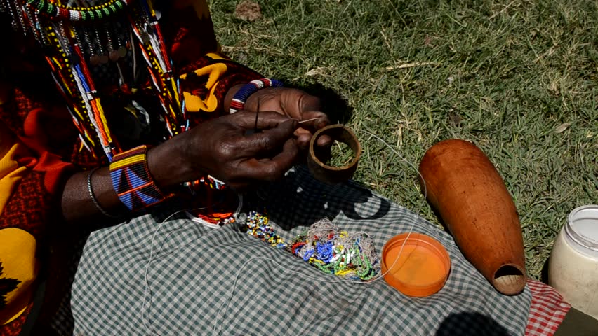 Masai woman making jewelry
