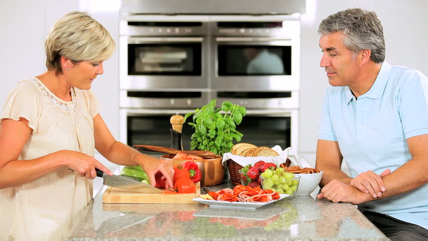 Healthy Mature Couple Preparing Salad for Lunch