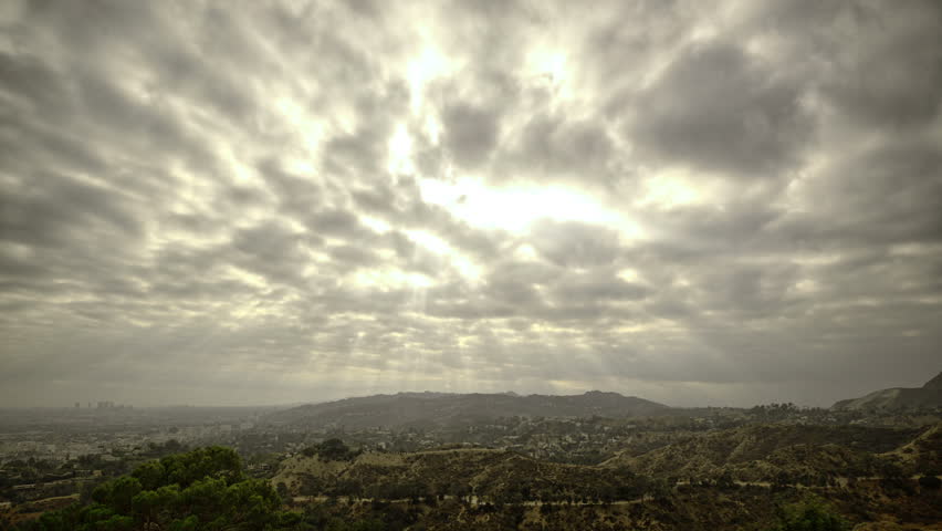 Cloud time lapse with sunbeams over the hollywood hills