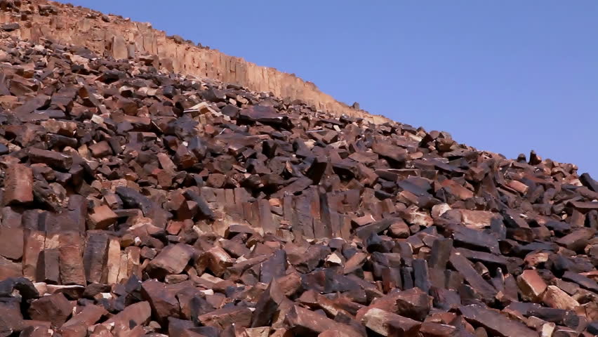 Pan left to right and down the rocky hillside of Ha-Minsara (The Carpentry Shop), a geological formation in the Mitzpe Ramon Crater in Israel.  