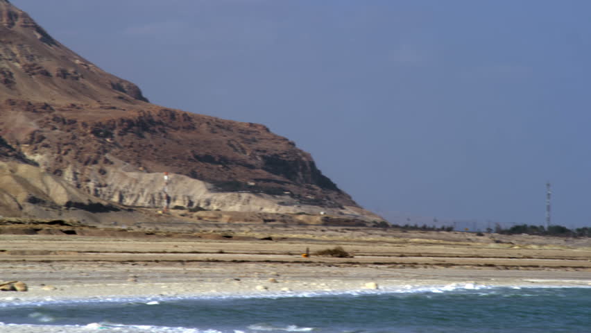 Pan right to left from the barren mountains of Ein Gedi in Israel, to the blue water of the Dead Sea.  02/27/2011