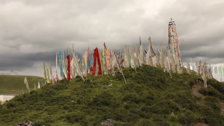 Tibetan flags ripple in the wind near Tagong, China