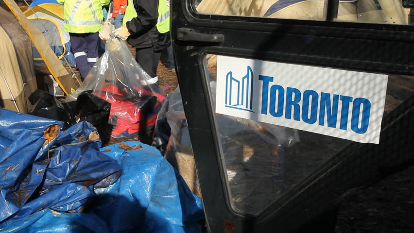 TORONTO, ONTARIO - NOV 23th: City workers dismantle the Occupy Toronto site on Nov 23rd, 2011, Toronto, Ontario, Canada. The site was closed down on Nov 23rd  following a superior court judge ruling.