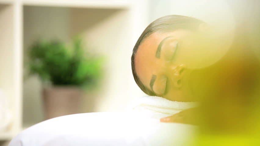 Health Spa Client Relaxing with Hot Stone Therapy