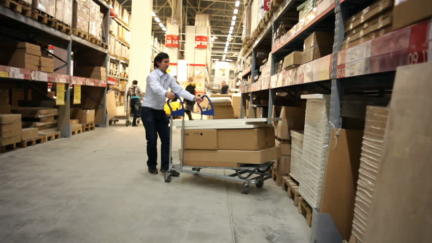 Warehouse. Man takes a box. 
