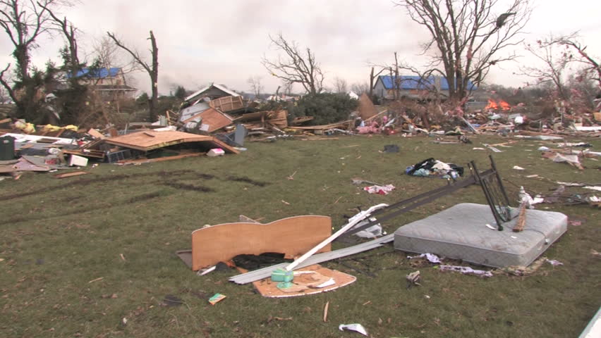 Panning across the path of destruction of a tornado, with demolished homes. 