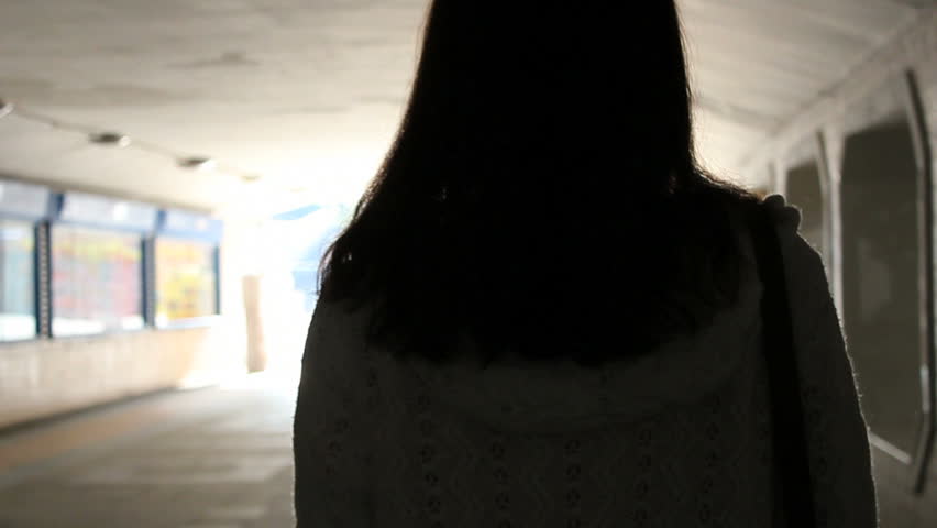 girl walks towards light .slowmotion.