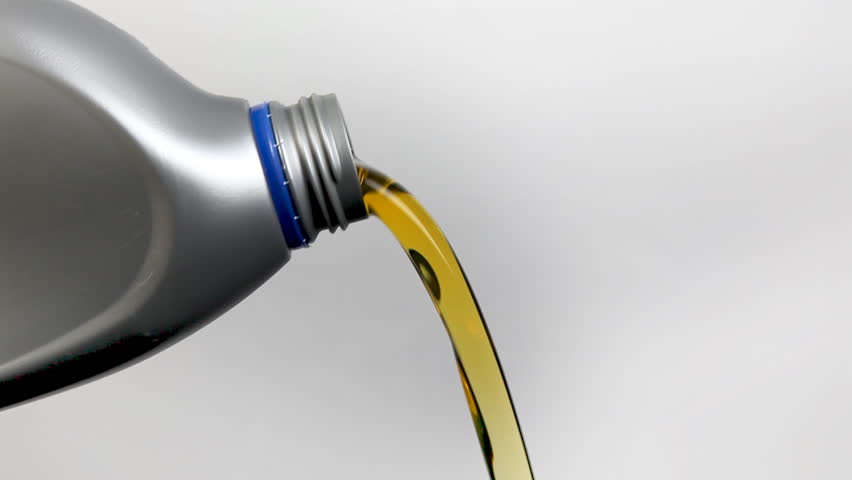 Motor Oil Pouring from Plastic Bottle
