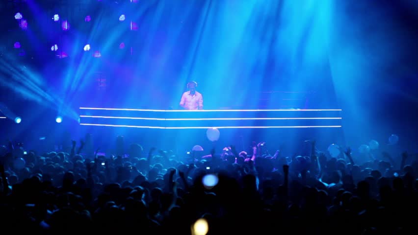 MOSCOW - MAY 6: Popular Dutch DJ Armin Van Buuren on stage with blue illumination, lot of people, on May 6, 2011 in Moscow, Russia.