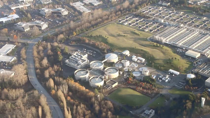 Low-flying crossing view of sewage treatment facility