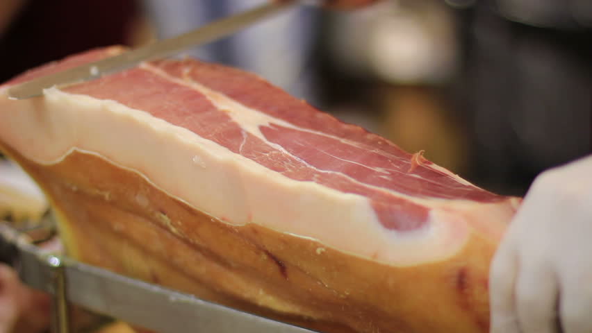 Expert caterer slicing ham - Typical European food