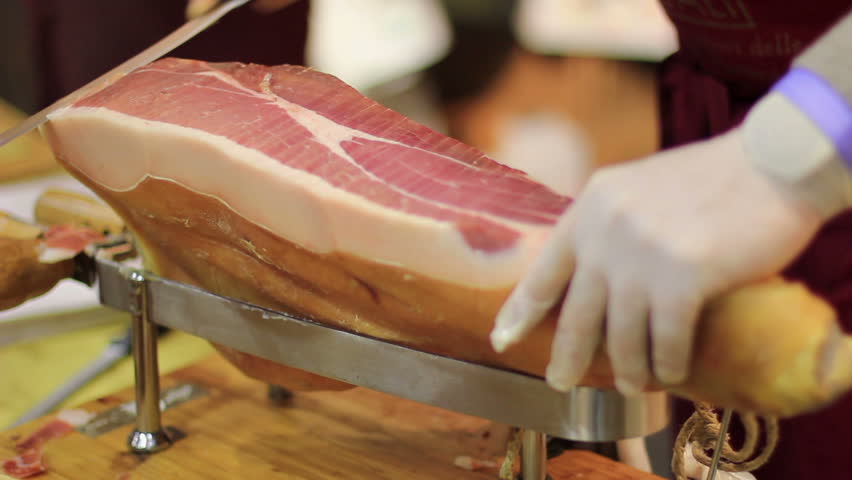 Expert caterer slicing ham - Typical European food