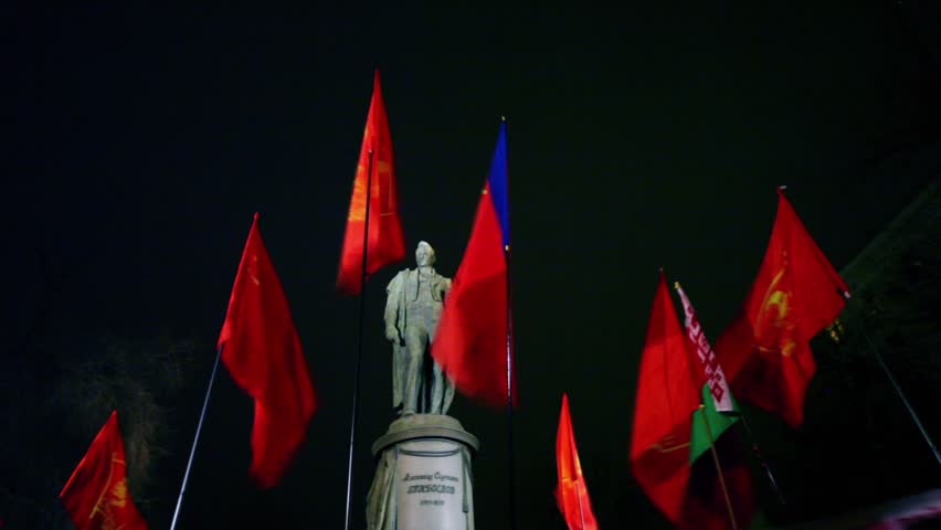 Several communistic flags in front of Griboyedov monument