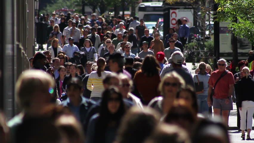 CHICAGO - CIRCA SEPTEMBER 2011 - A backlit crowd of people walks on a wide sidewalk along Michigan Avenue in slow motion