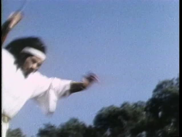 Asian warrior doing triple somersault