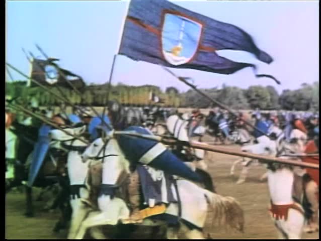 Wide shot medieval soldiers on horseback galloping into battle