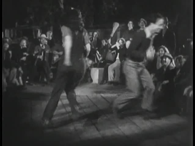 Crowd watching people dancing outdoors
