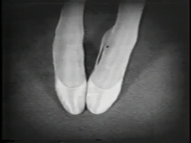 Close-up of feet in ballet slippers