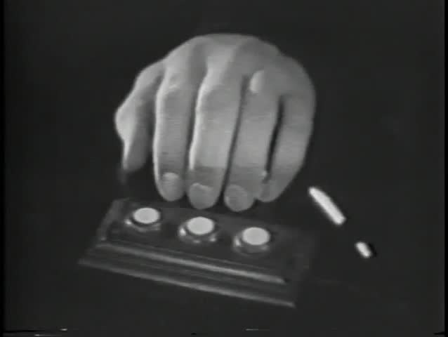 Close-up of shaking hand pushing button