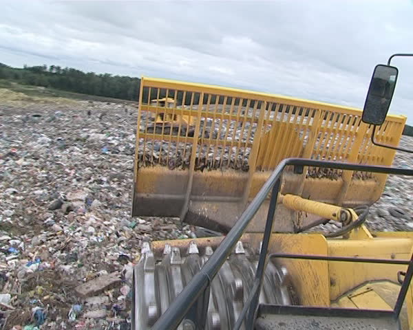 Riding heavy dump rubbish pressing truck. Environmental pollution. 